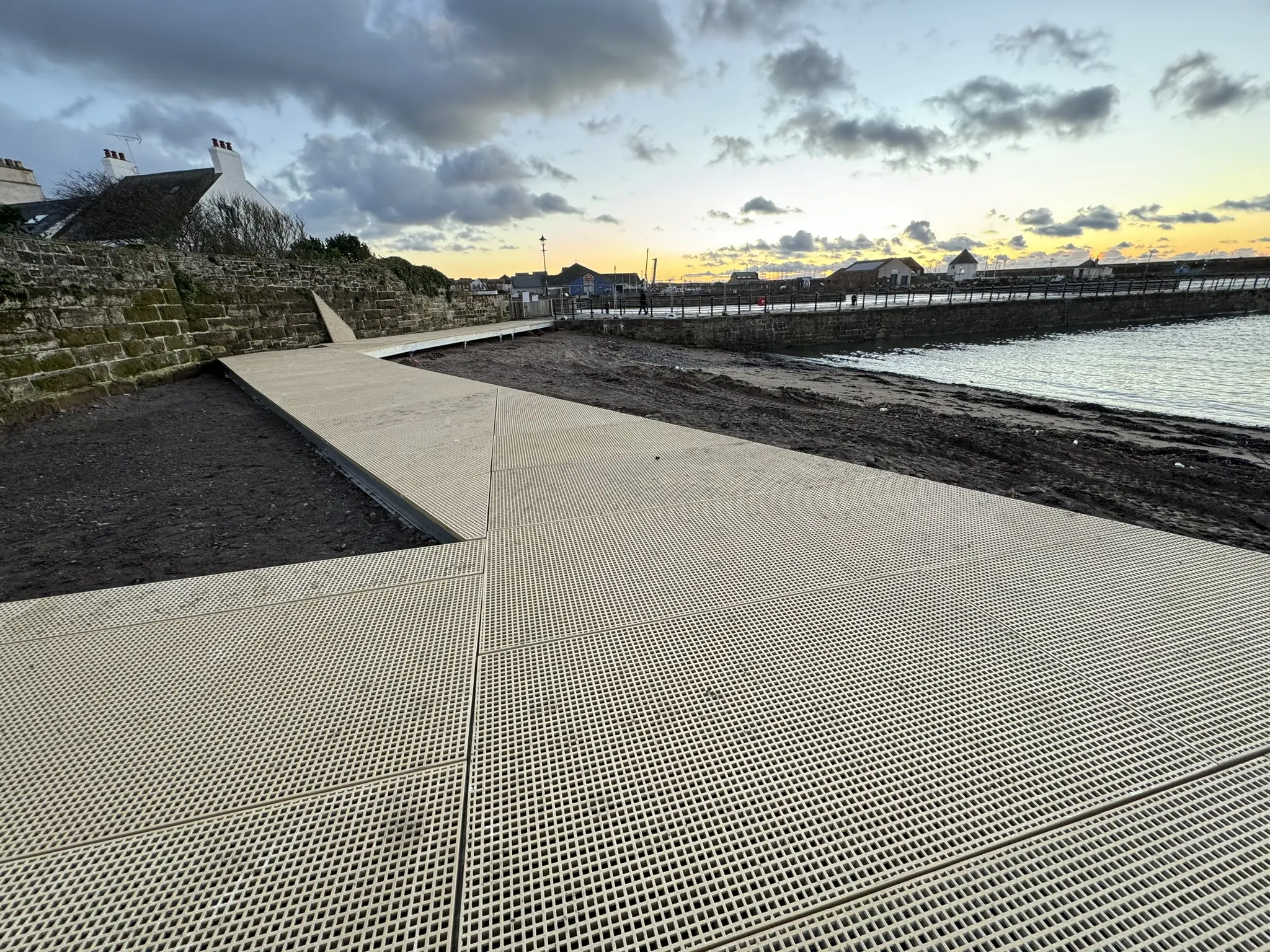 Completed non-slip decking forming the accessible Maryport Boardwalk route beside the sea