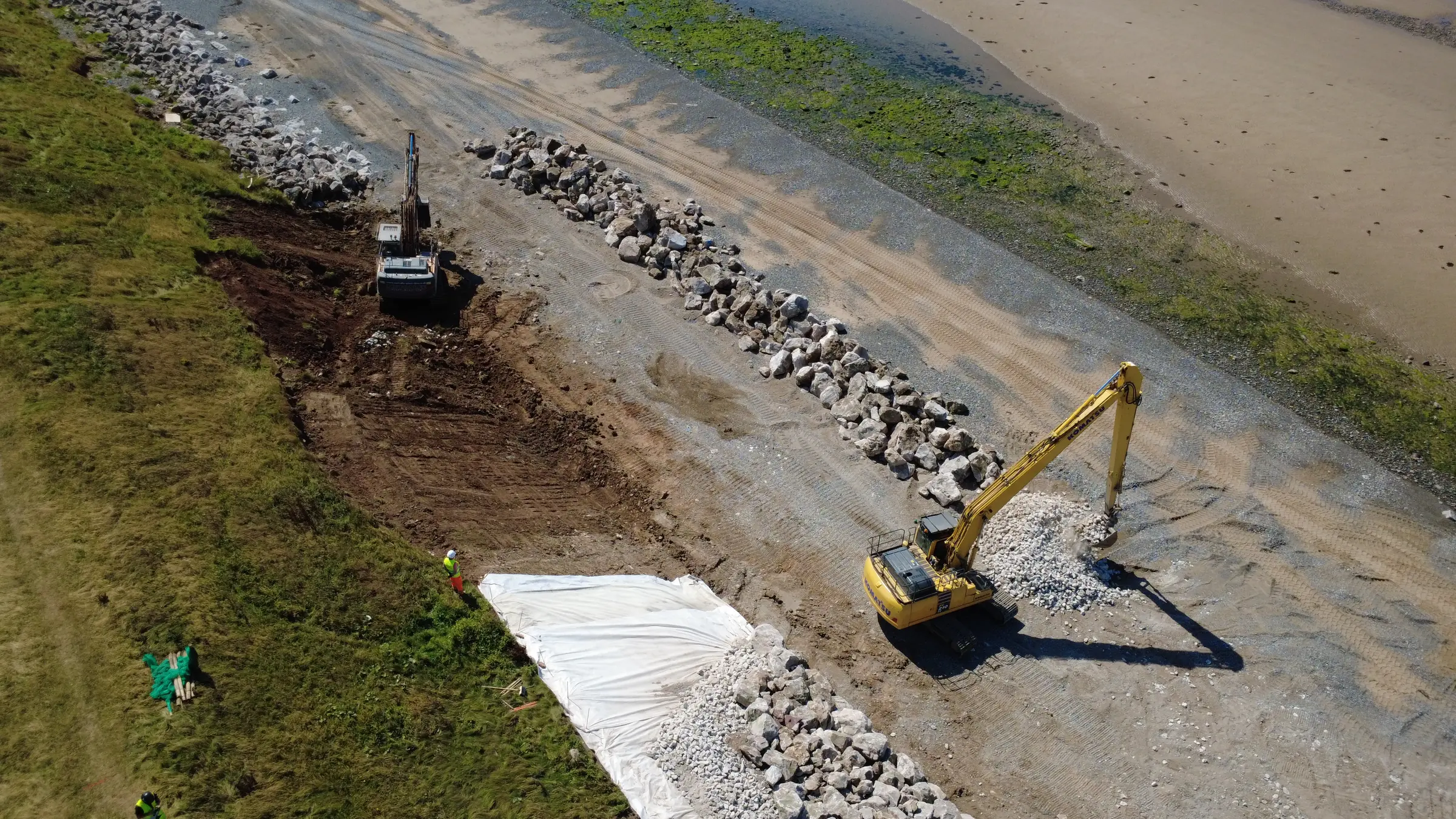 Sharp aerial view of Cowran Estate Services placing rock armour and engineered liner at South Walney