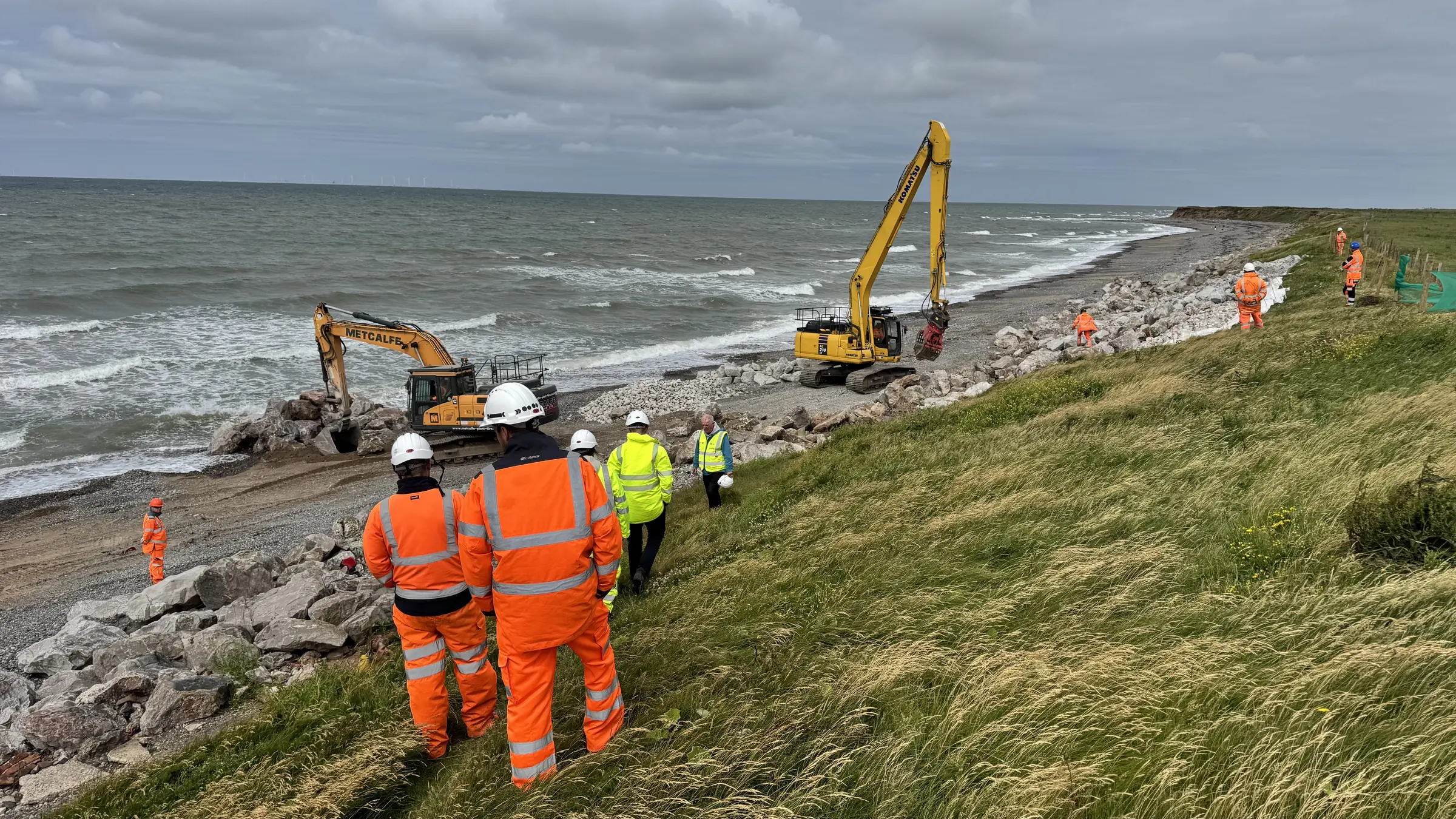 Cowran Estate Services team and excavators delivering rock-armour coastal protection beside the sea at South Walney